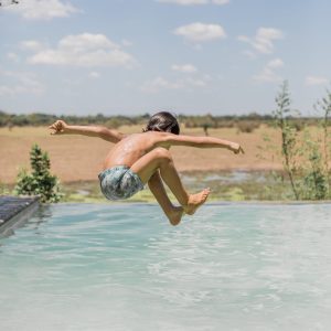 KafuntaSafaris_Dec_2021_Izlaphotography085 Kid jumping in pool